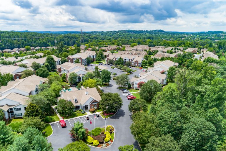 An aerial view of a residential neighborhood featuring 42 apartment properties managed by a professional property management company.
