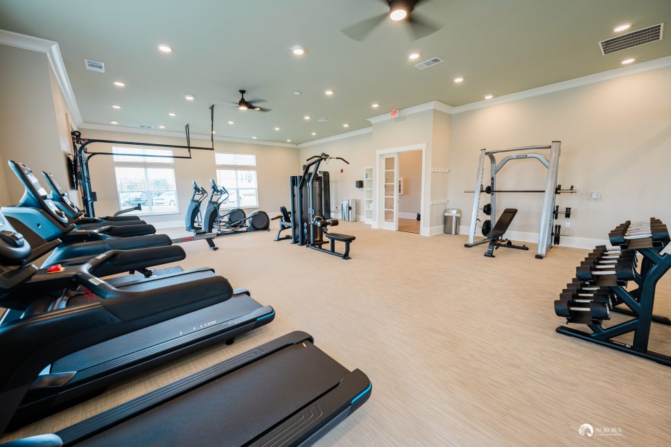 A 42 Apartment Property Management gym room equipped with tread machines and a refreshing ceiling fan.