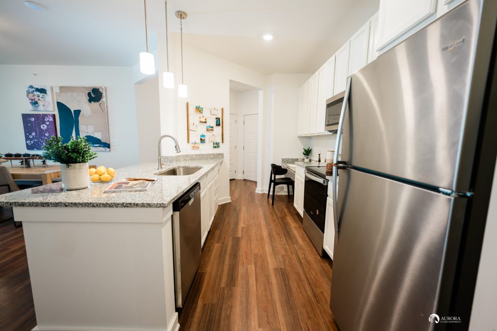 A kitchen with a stainless steel refrigerator that perfectly complements the 42 Apartment Property Management's modern aesthetic.